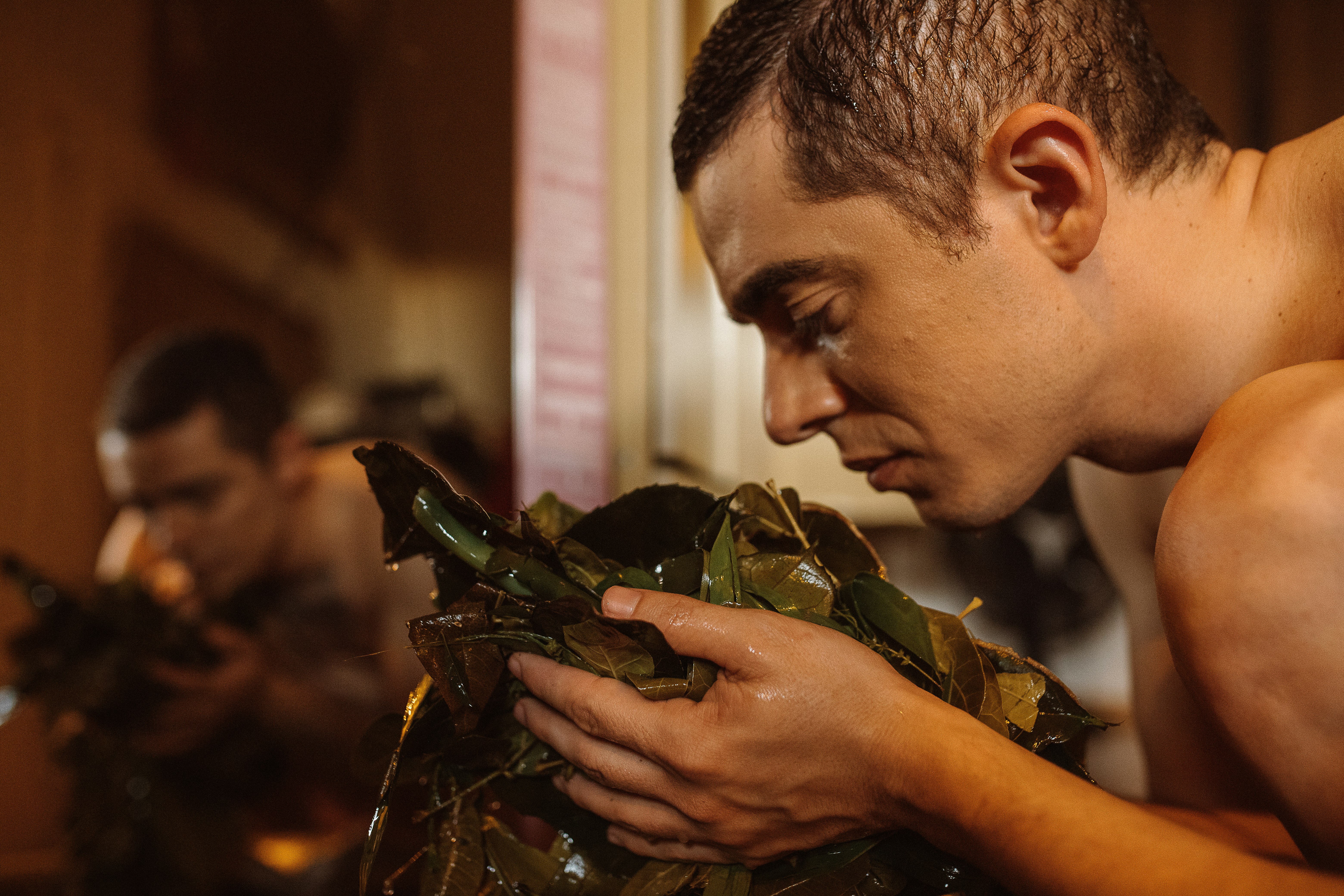 man in green and brown camouflage shirt holding green leaves